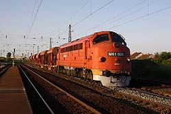 MAV Nosztalgia M61.006 provides the traction for a ballast train while it is overtaken by a southbound Rail Cargo Hungary freight train with MAV 630 012 at the helm at Emod on 20 May 2014.